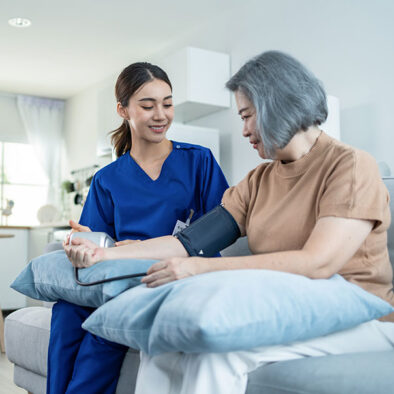 Nurse checking blood pressure on patient