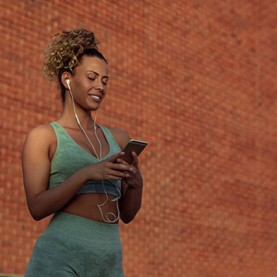 Woman exercising checking goals on phone