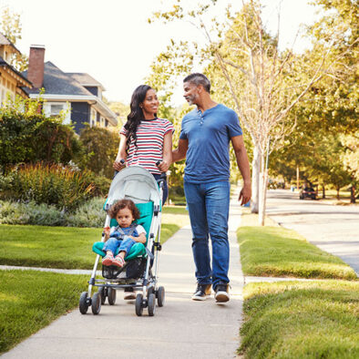 Family walking baby in stroller